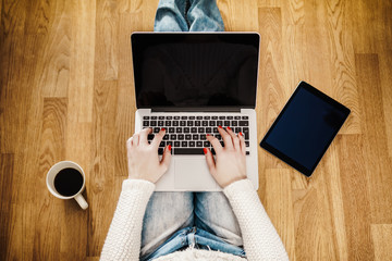 Fototapeta premium top view of a young woman with a computer on her lap