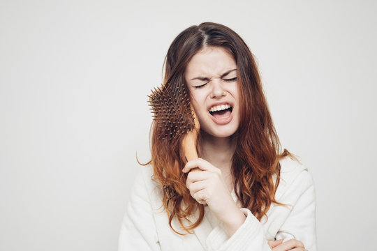 Woman Combing Unruly Hair