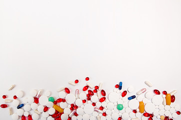 Heap of tablets and pills on white background. Copy space.