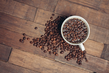 light cup covered with coffee beans