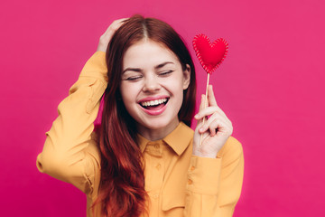 woman on a pink background, holiday, hearts, a day of lovers