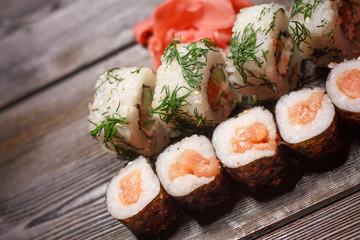 sushi with seafood and ginger on a wooden background
