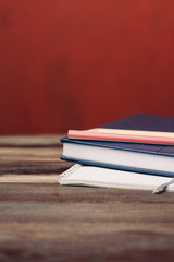 a stack of notebooks on the table