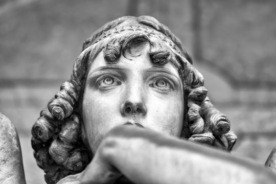 Portrait of loving angel on marble, monumental cemetery of Genoa, Italy, one of the most important monumental cemeteries in Europe.