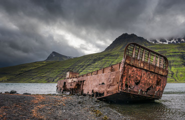 Mjoifjordur, Iceland - Abandoned fishing boat rusts in fjord