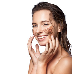 Closeup of a woman making a face peeling scrub on a white background