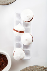 Meringue cookies with chocolate on white background