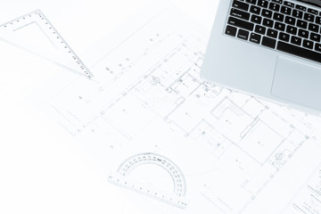 drawing rulers, and notebook over house construction blueprint w
