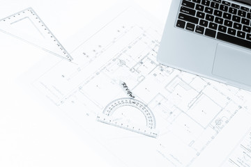 drawing rulers, and notebook over house construction blueprint w