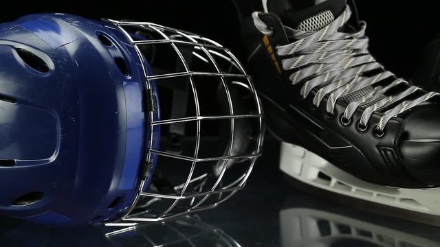 Close-up dolly shot on hockey skates and hockey helmet.