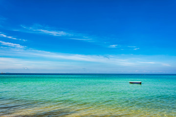 Fototapeta premium Boat on Blue sea and a moving reflection