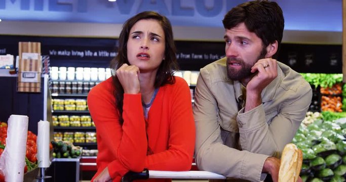 Couple ignoring each other in organic section