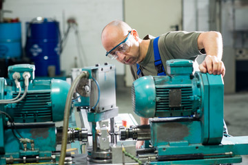 worker in factory on the machine