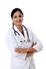 Fototapeta premium Smiling young doctor woman against white background