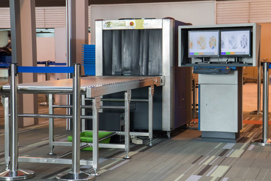 X-ray scanner and metal detector with monitor at airport security checkpoint
