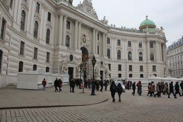 Fototapeta premium Michaelerplatz square in Vienna at day time, facing the Hofburg complet entrance and people around