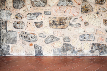 Fototapeta na wymiar Gray stone wall and red floor tiling