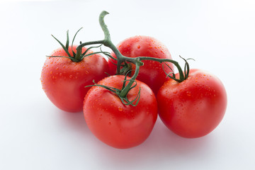 Four big red tomato on a white background