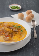 cabbage soup with tomatoes and bread rolls
