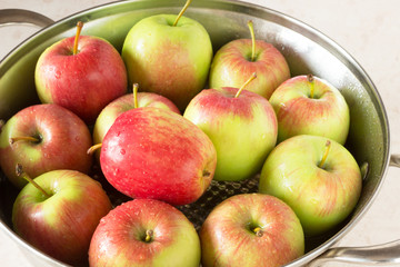 Red and green apples on   a plate