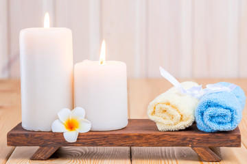 Fototapeta na wymiar towels and burning candles close-up still life with frangipani