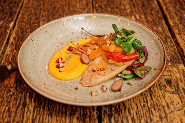 Seafood starter with orange slices and pumpkin mash