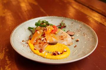 Seafood starter with orange slices and pumpkin mash