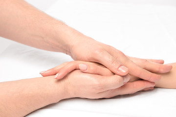 Naklejka premium hand massage in the salon of a physiotherapist on a white backgr