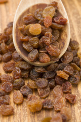 Raisins on a wooden spoon