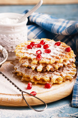 Waffles and sugar bowl with sugar powder