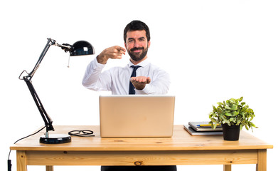 Businessman in his office holding something