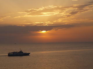 Naklejka na ściany i meble sailing boat on sea during sunset