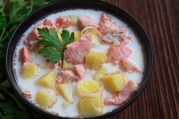 Salmon soup with cream, potatoes, parsley