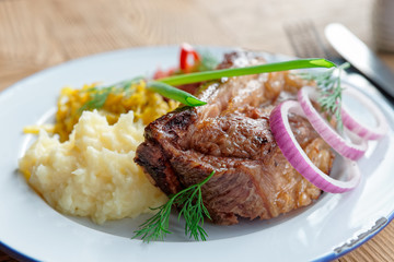 Grilled pork ribs with sauerkraut and mashed potatoes