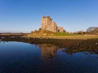 Aerial Dunguaire Castle Evening Sunset, near Kinvarra in County Galway, Ireland - Wild Atlantic Way Route. Famous public tourist attraction in Ireland.