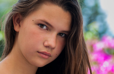 Portrait of a young girl with pink flowers