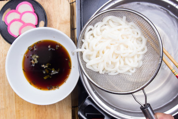 Chef putting udon noodle to cup