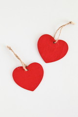 Red wooden heart shaped tag with rope isolated on white
