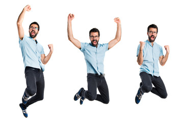 Handsome man with blue glasses jumping