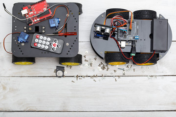 Two robot on wheels and elements necessary for the robot assembl