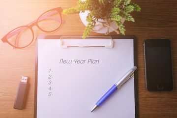 Fototapeta premium Business concept - Top view notebook writing New Year Plan.