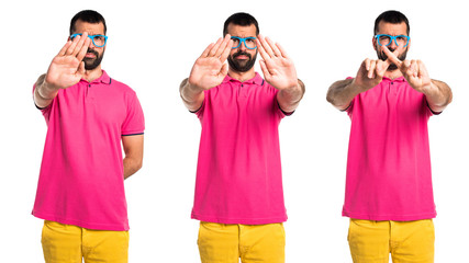 Man with colorful clothes making stop sign