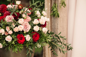 Roses and peons in vase on table close-up