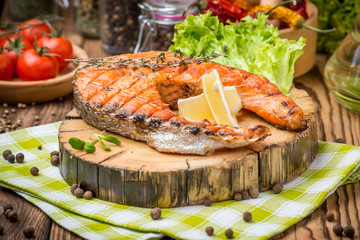 grilled salmon steak on a plate made of wood