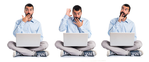 Man with laptop doing surprise gesture