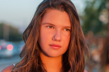 Young, teenage girl's face in sunset.