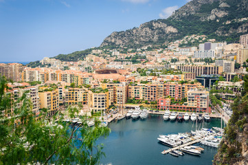 Fototapeta na wymiar Monte Carlo harbour city panorama. View of luxury yachts and apartments in harbor of Monaco