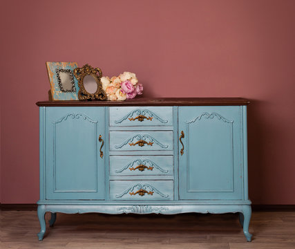 Vintage Blue Wooden Dresser, Tender Bouquet And Two Frames. Blue And Brown Vintage Interior. Brown Room With Ethnic Dresser. Antique Cupboard. Clothes Closet. Vanity Table