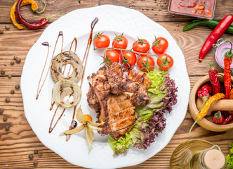grilled beef steak on the grill on a wooden table