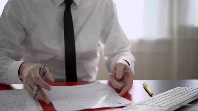 Man reviewing paperwork at his desk